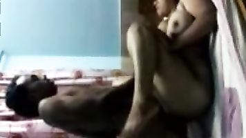 Desi bhabhi in kameez hiked up and juicy big boobs exposed and pressed by tharki dewar who also pulls down her salwar to show her ass cheeks and caresses them in this MMS.