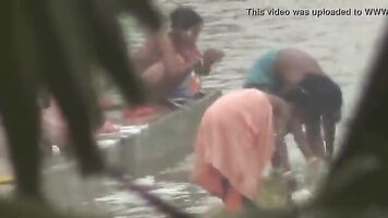 Tamil women bathing by the river